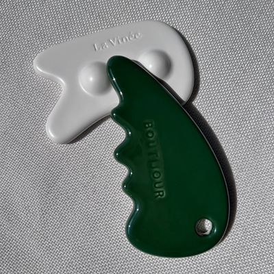 Gesichtsmassager Gua Sha Stein in grüner Farbe für Selbstpflege und Schönheitssalon